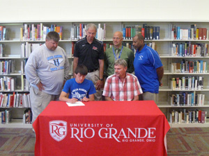 Gallia Academy's Tyler Campbell is surrounded by family and coaches as he signs to run at Rio Grande